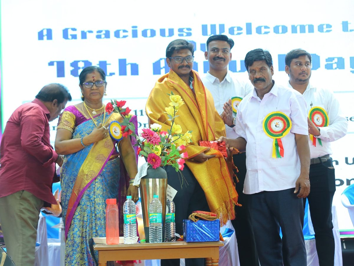 The chief guest being honoured with a shawl on stage at the 18th Annual Day