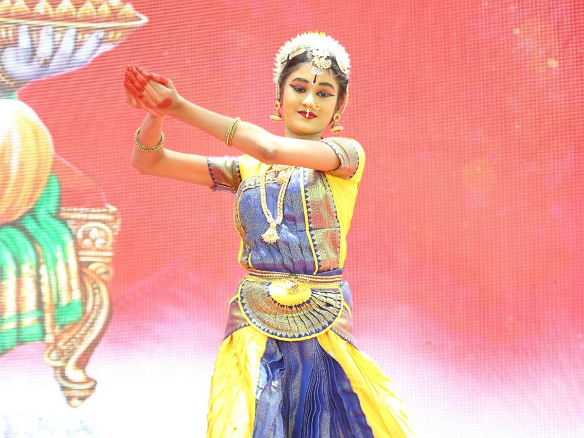 A student performing a solo Bharatanatyam dance on the Annual Day stage
