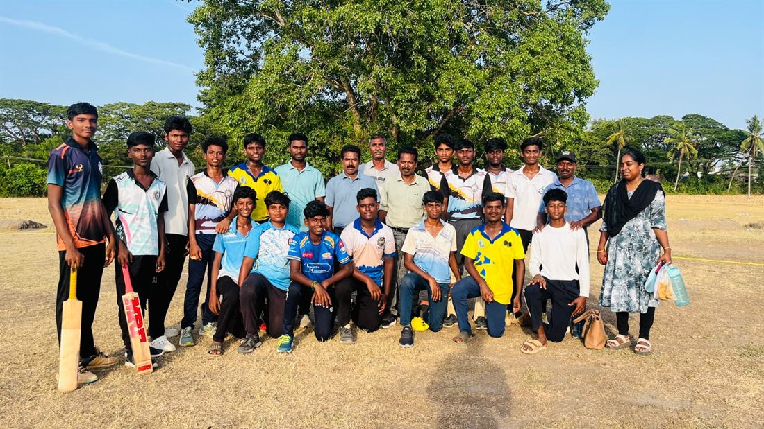 The school cricket team with their teachers on the ground