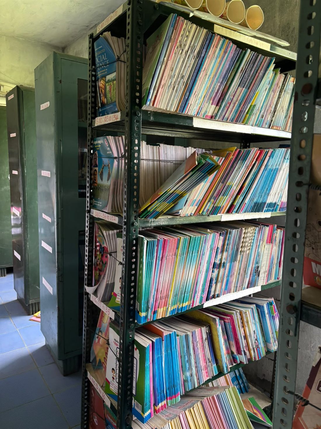 The library shelves, stacked with books for every class
