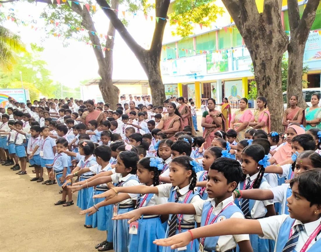 Students at morning assembly, taking the pledge